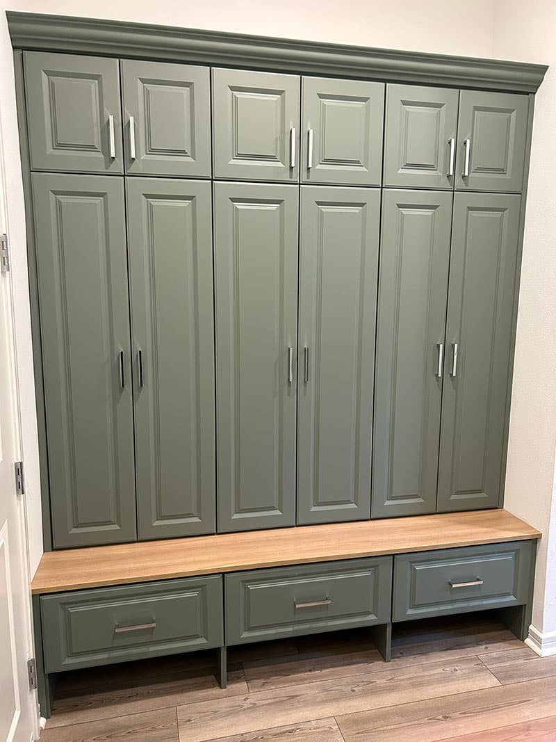 Green mudroom lockers with a bench